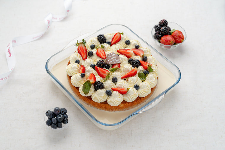 Yummy Bakes Classic Milk Cake topped with fresh berries